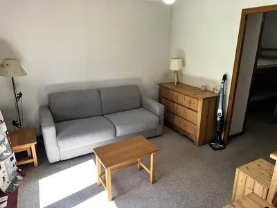 a living room with a couch and a wooden dresser at Résidence Ecrin Des Glacier Aiglon - Ecrin des glaciers Aiglon 14 MAE-2783 in Combloux