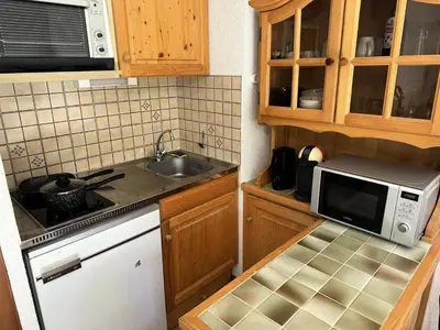 a small kitchen with a sink and a microwave at Résidence Ecrin Des Glacier Aiglon - Ecrin des glaciers Aiglon 14 MAE-2783 in Combloux