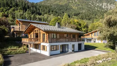 a log cabin in the snow with a balcony at Chalet Monski in Les Houches