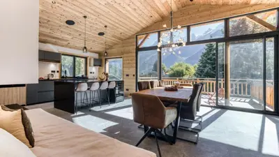 a kitchen and dining room with a table and chairs at Chalet Monski in Les Houches
