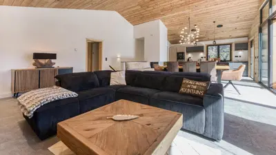 a living room with a couch and a table at Chalet Monski in Les Houches