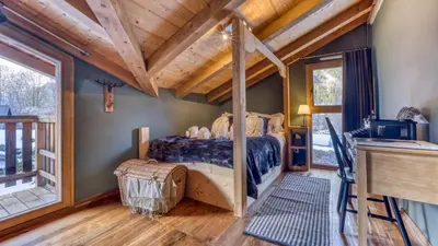 a bedroom with a bed and a wooden ceiling at Chalet Deutz in Chamonix-Mont-Blanc