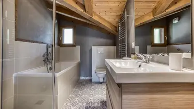 a bathroom with a sink and a tub and a toilet at Chalet Deutz in Chamonix-Mont-Blanc
