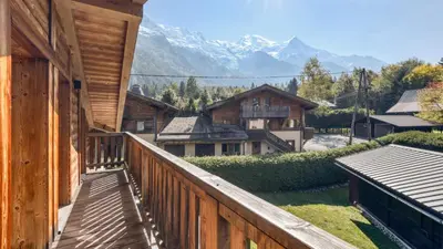 a balcony of a house with a view of mountains at Chalet Deutz in Chamonix-Mont-Blanc