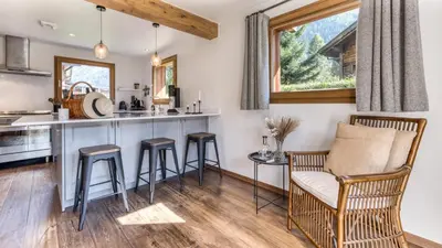 a kitchen with a counter and stools in a room at Chalet Deutz in Chamonix-Mont-Blanc
