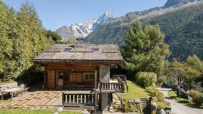 a wooden fence with mountains in the background at Chalet Mowgli in Chamonix-Mont-Blanc