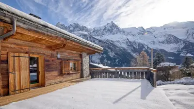 a log cabin in the mountains with snow at Chalet Mowgli in Chamonix-Mont-Blanc