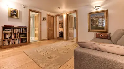 a room with a bench and a wall with hockey sticks at Chalet Mowgli in Chamonix-Mont-Blanc