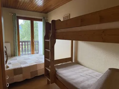 two bunk beds in a room with a window at Appartement aux Carroz d'Arâches, 4 pers, 39 m² - FR-1-572-327 in Arâches-la-Frasse