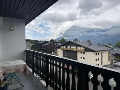 a balcony with a table and a view of mountains at Appartement aux Carroz d'Arâches, 4 pers, 39 m² - FR-1-572-327 in Arâches-la-Frasse