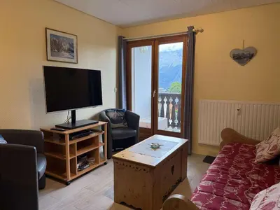 a living room with a flat screen tv and a couch at Appartement aux Carroz d'Arâches, 4 pers, 39 m² - FR-1-572-327 in Arâches-la-Frasse