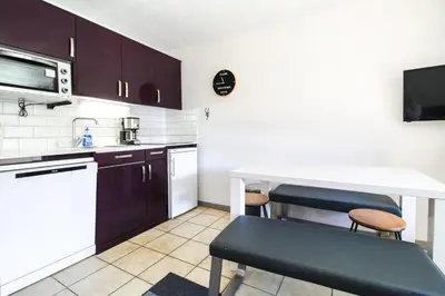 a small kitchen with a table and a counter at Joli T2 Flaine Foret, oriente sud, linge & menage compris in Flaine
