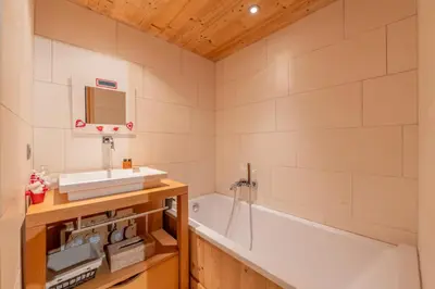 a bathroom with a tub and a sink at Luxury Chalet Pool & Jacuzzi near Megeve in Sallanches