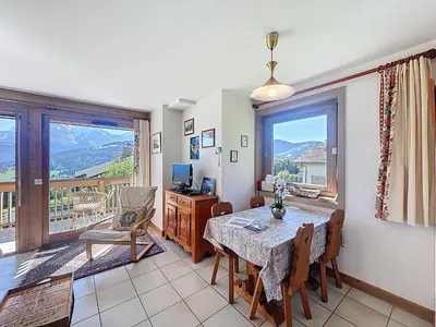 a dining room with a table and a large window at Appartement 2 chambres, vue Mont Blanc, parking inclus - FR-1-560-168 in Combloux