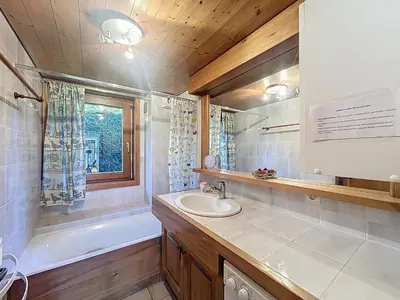 a bathroom with a sink and a bath tub and a mirror at Appartement 2 chambres, vue Mont Blanc, parking inclus - FR-1-560-168 in Combloux