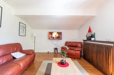a living room with a couch and a table at Grand Appartement-Vue Montagne-Wi-Fi-Parking in Magland
