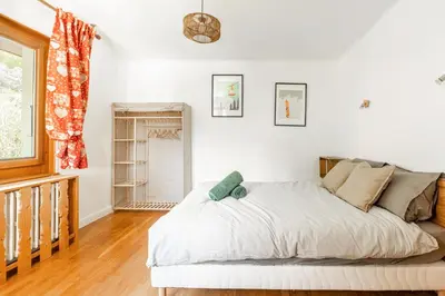 a bedroom with a white bed and a window at Grand Appartement-Vue Montagne-Wi-Fi-Parking in Magland