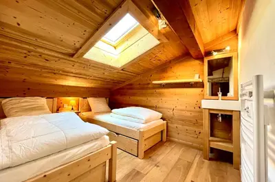 a bedroom with two beds in a wooden cabin at Charming Alpine Apartment in Megève Mountain View in Megève