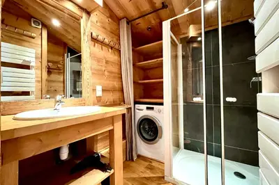 a bathroom with a sink and a washing machine at Charming Alpine Apartment in Megève Mountain View in Megève