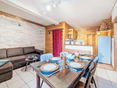 a living room with a table and a couch at Apartment Au Bon Coin by Interhome in Saint-Gervais-les-Bains