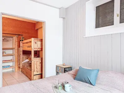 a bedroom with a large bed and a window at Apartment Au Bon Coin by Interhome in Saint-Gervais-les-Bains