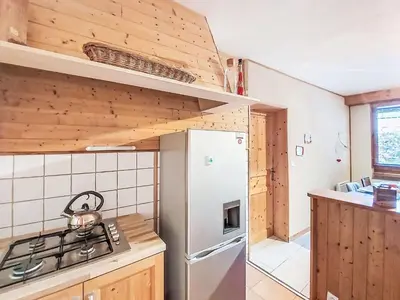 a kitchen with wooden cabinets and a counter top at Apartment Au Bon Coin by Interhome in Saint-Gervais-les-Bains