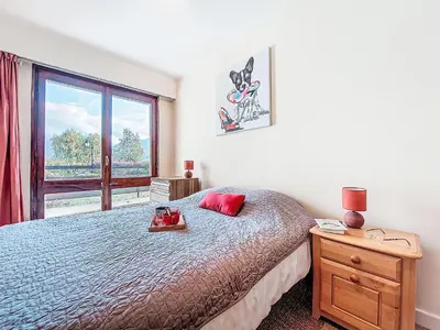 a bedroom with a bed and a window at Apartment Beaulieu by Interhome in Saint-Gervais-les-Bains