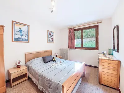 a bedroom with a bed and a window at Apartment Beaulieu by Interhome in Saint-Gervais-les-Bains