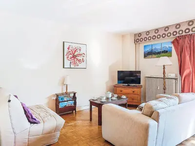 a living room with a couch and a tv at Apartment Beaulieu by Interhome in Saint-Gervais-les-Bains