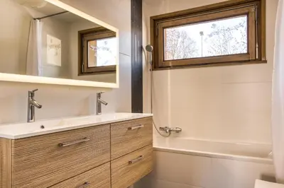 a bathroom with a sink and a mirror at Appartements dans le Chalet Nessa - Combloux in Combloux