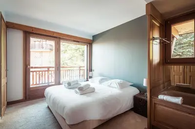 a bedroom with a bed with two towels on it at Les Cimes d'Eden - Cozy duplex in Megève in Megève