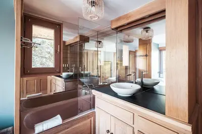 a bathroom with two sinks and a large mirror at Les Cimes d'Eden - Cozy duplex in Megève in Megève