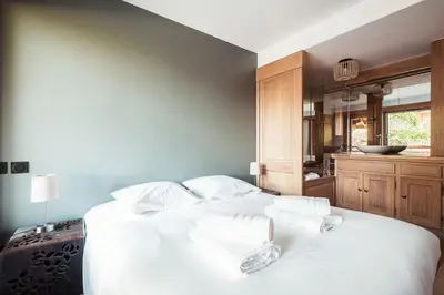 a bedroom with a white bed with two towels on it at Les Cimes d'Eden - Cozy duplex in Megève in Megève