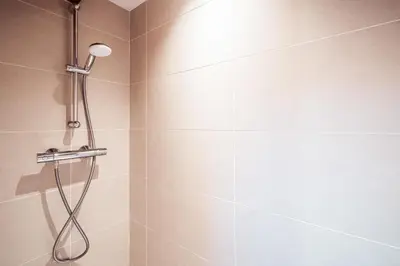 a shower with a shower head in a bathroom at Les Cimes d'Eden - Cozy duplex in Megève in Megève
