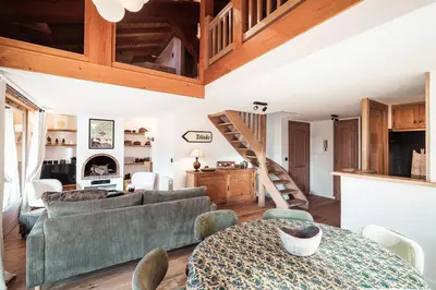 a living room with a couch and a table at Les Cimes d'Eden - Cozy duplex in Megève in Megève