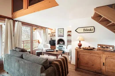 a living room with a couch and a table at Les Cimes d'Eden - Cozy duplex in Megève in Megève