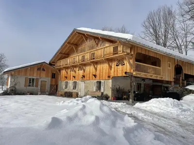 a large wooden barn with snow on the ground at Chalet spacieux à Samoëns, 6 chambres, idéal pour 14 personnes avec Wifi - FR-1-846-1 in Samoëns
