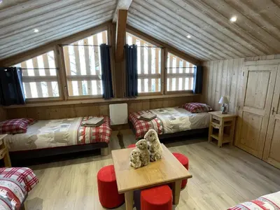 two teddy bears sitting on a table in a room at Chalet spacieux à Samoëns, 6 chambres, idéal pour 14 personnes avec Wifi - FR-1-846-1 in Samoëns