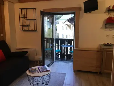 a living room with a door leading to a balcony at Studio cosy pour 4 à Samoëns - FR-1-846-4 in Samoëns