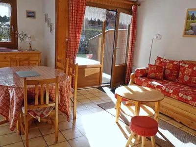 a living room with a couch and a table at Appartement cosy 2 pièces avec Wifi à Samoëns - FR-1-846-10 in Samoëns