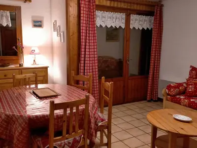 a kitchen and a dining room with a table and chairs at Appartement cosy 2 pièces avec Wifi à Samoëns - FR-1-846-10 in Samoëns