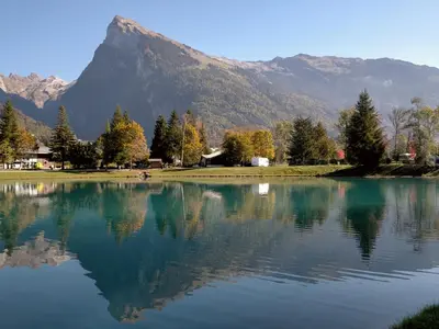 a large lake with a mountain in the background at Appartement cosy 2 pièces avec Wifi à Samoëns - FR-1-846-10 in Samoëns