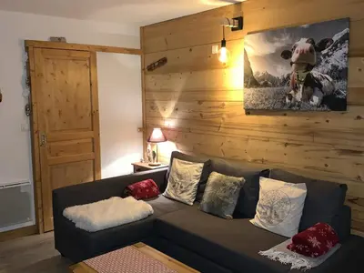 a living room with a couch with pillows on it at Studio confortable à Samoëns 1600 pour 4 personnes - FR-1-846-3 in Samoëns