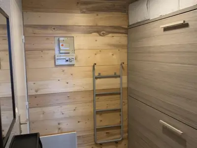 a room with a wooden wall with a ladder at Studio confortable à Samoëns 1600 pour 4 personnes - FR-1-846-3 in Samoëns