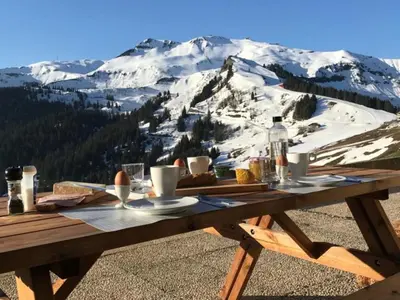 a picnic table with food on top of a snow covered mountain at Studio confortable à Samoëns 1600 pour 4 personnes - FR-1-846-3 in Samoëns