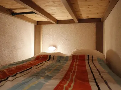 a bed in a room with a wooden ceiling at Studio confortable pour 5 personnes à Samoëns - FR-1-846-13 in Samoëns