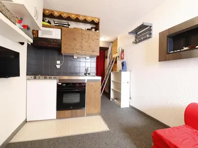 a room with a refrigerator and a table with a bag on it at Studio confortable pour 5 personnes à Samoëns - FR-1-846-13 in Samoëns