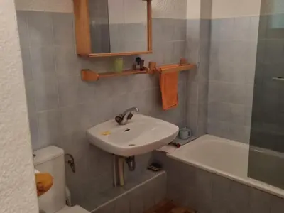 a bathroom with a sink and a tub and a toilet at Appartement cosy avec Wifi à l'orée du bois - FR-1-846-11 in Samoëns
