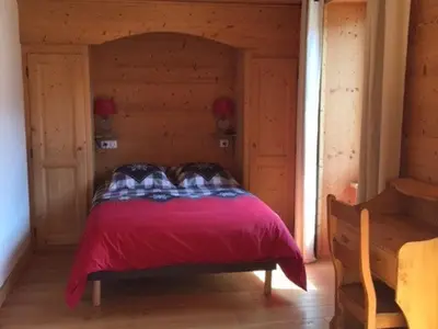 a bedroom with a bed with a red blanket at Grand chalet à Samoëns pour 11 personnes avec Wifi - FR-1-846-7 in Samoëns