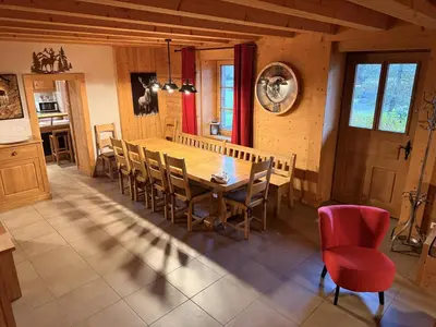 a kitchen and dining room with a wooden table and chairs at Grand chalet à Samoëns pour 11 personnes avec Wifi - FR-1-846-7 in Samoëns
